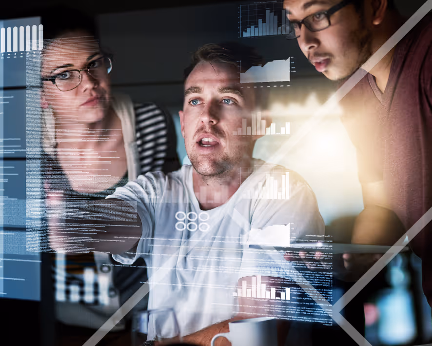 Three people working on a screen infront of them