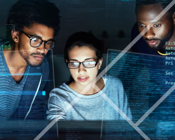 Three people working at a computer