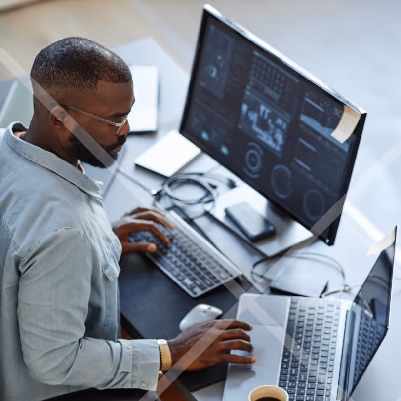 A man sitting infront of computer screens