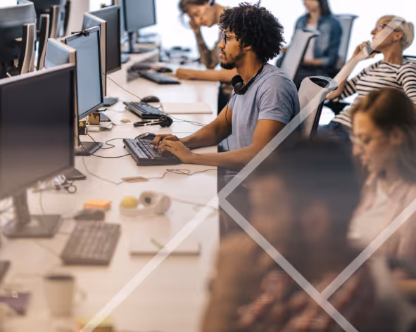 Busy office with men and women at their computers