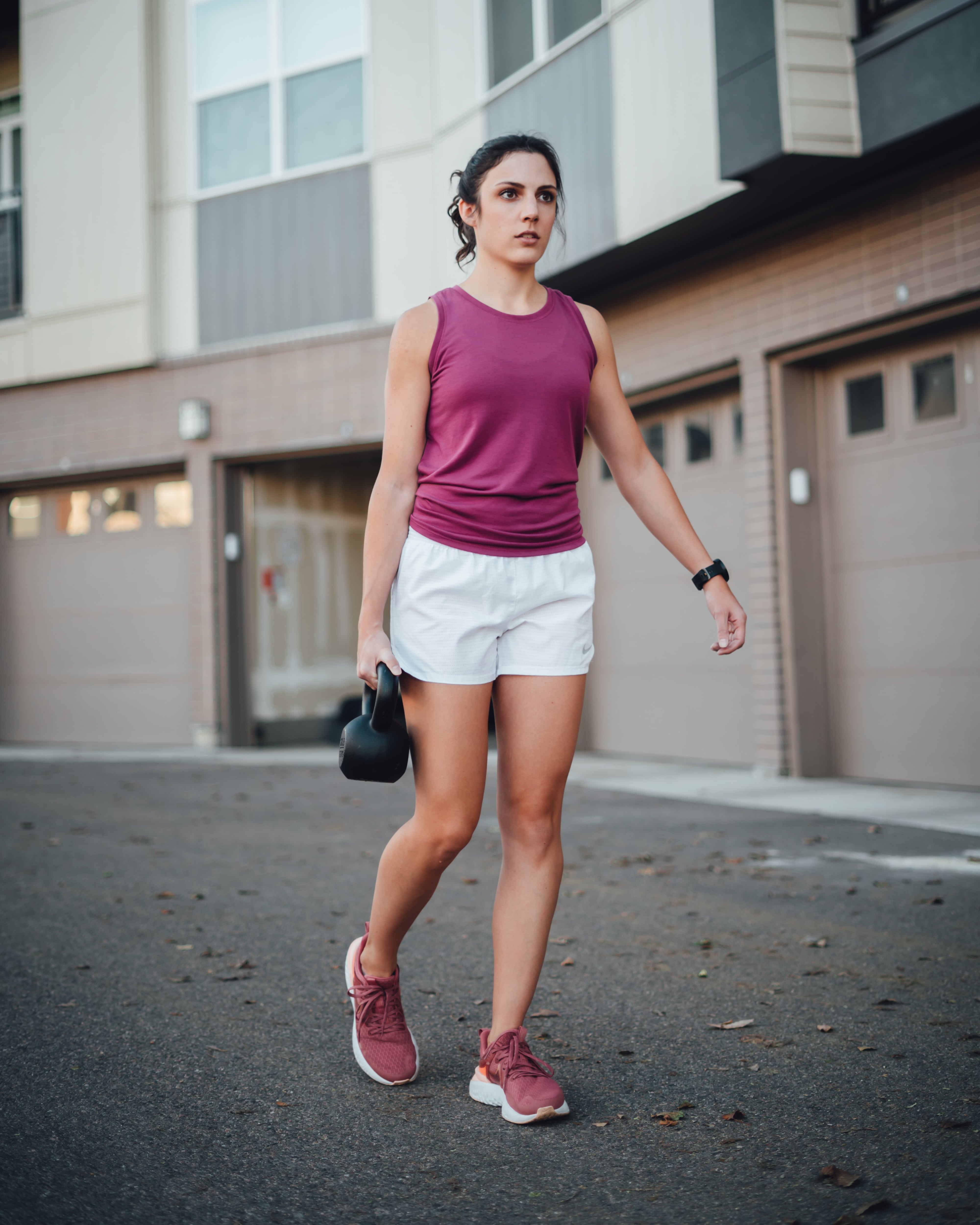 trainer doing a suitcase carry
