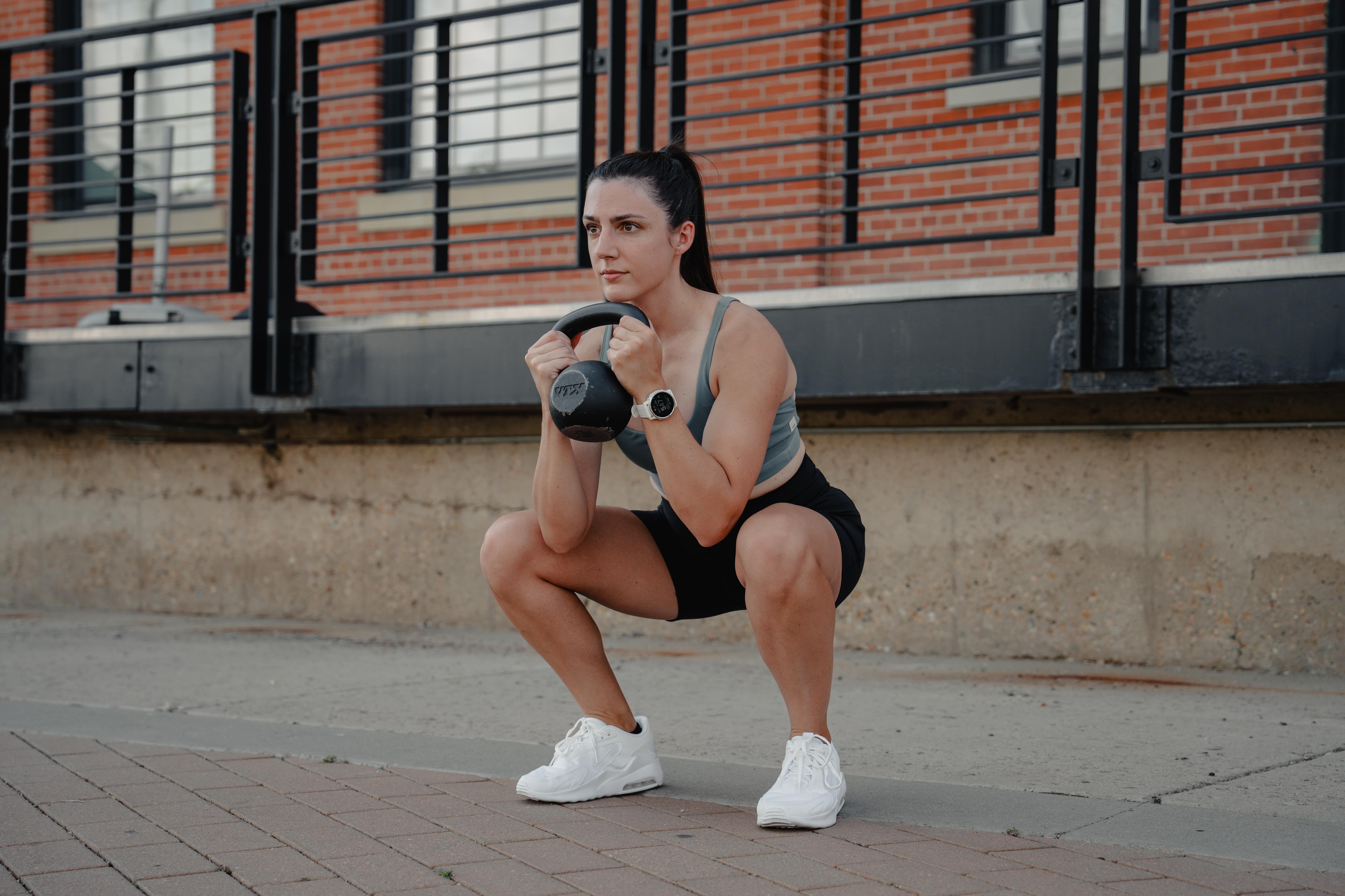 personal trainer squatting