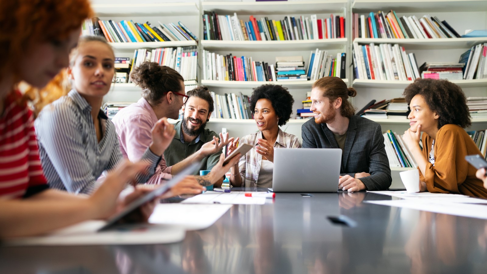 Business professionals engaging in a collaborative discussion in a modern conference room, exemplifying community and innovation in a multi-tenant office environment.