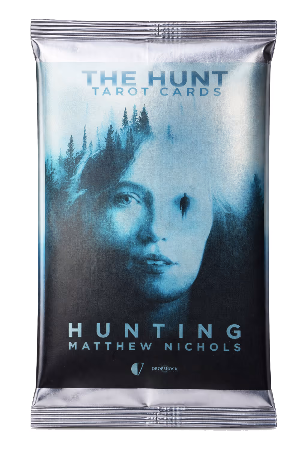 Packaged set of The Hunt Tarot Cards by Matthew Nichols featuring a blue-toned face and a person walking into fog among pine trees.