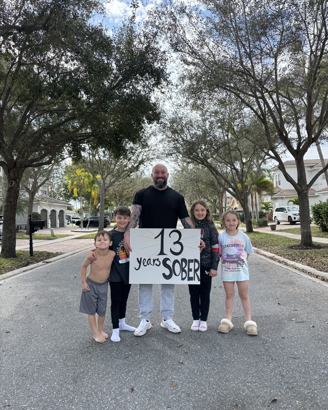 Christopher Ferry with his four children celebrating 13 years of sobriety
