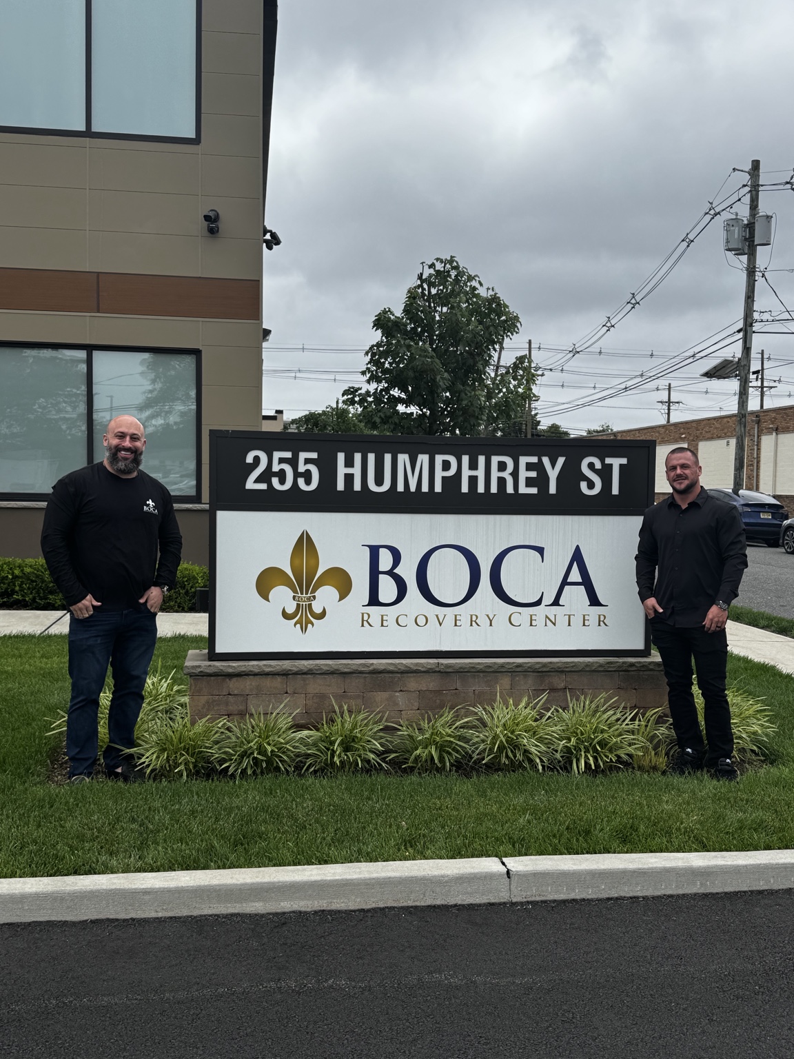 Christopher Ferry and COO Joe Toland at a Boca Recovery Center sign