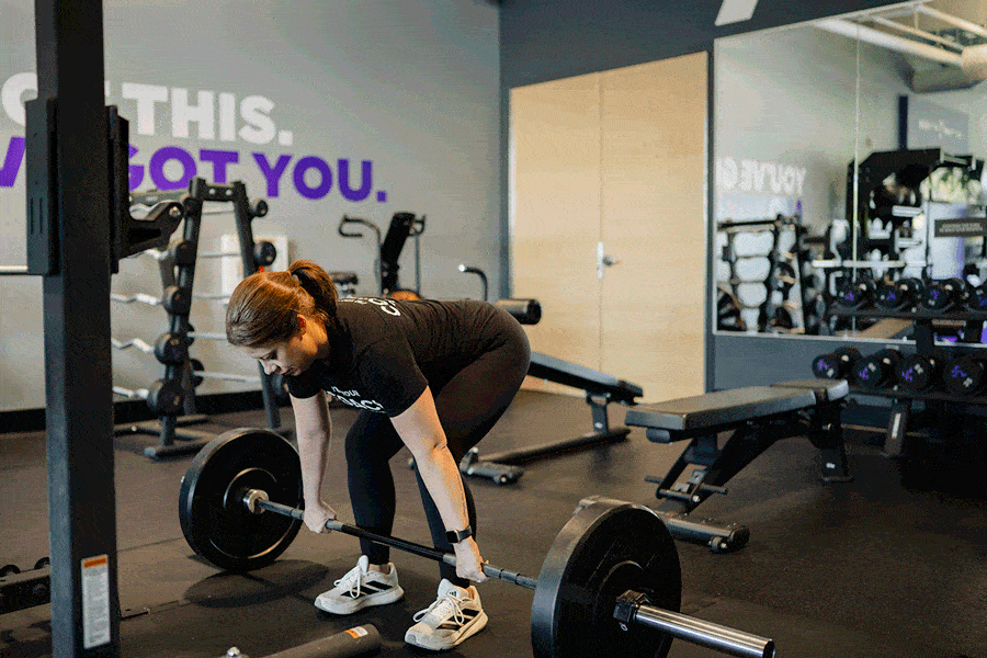 Anytime Fitness Coach demonstrating how to do a deadlift.