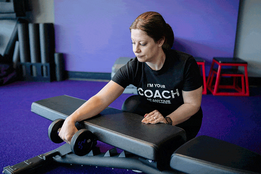 Anytime Fitness Coach demonstrating how to do a wrist extension.