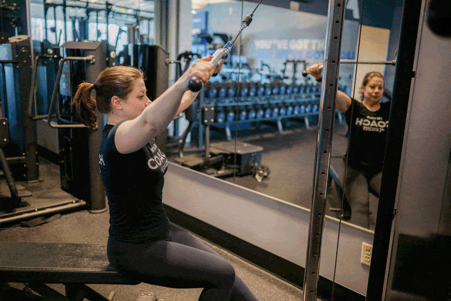 Anytime Fitness Coach demonstrating how to do a cable high row.
