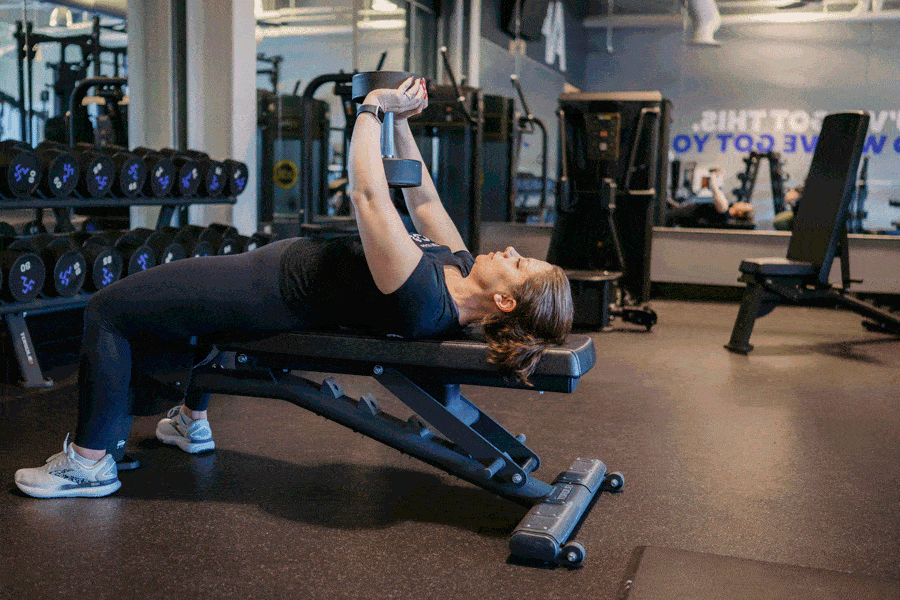 Anytime Fitness Coach demonstrating how to do a dumbbell pullover.