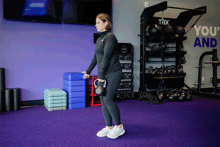 Anytime Fitness Coach demonstrating how to do a single-leg RDL.