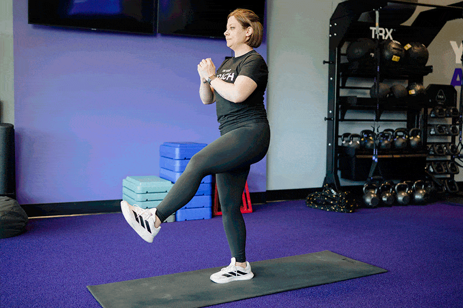 Anytime Fitness Coach demonstrating a pistol squat.