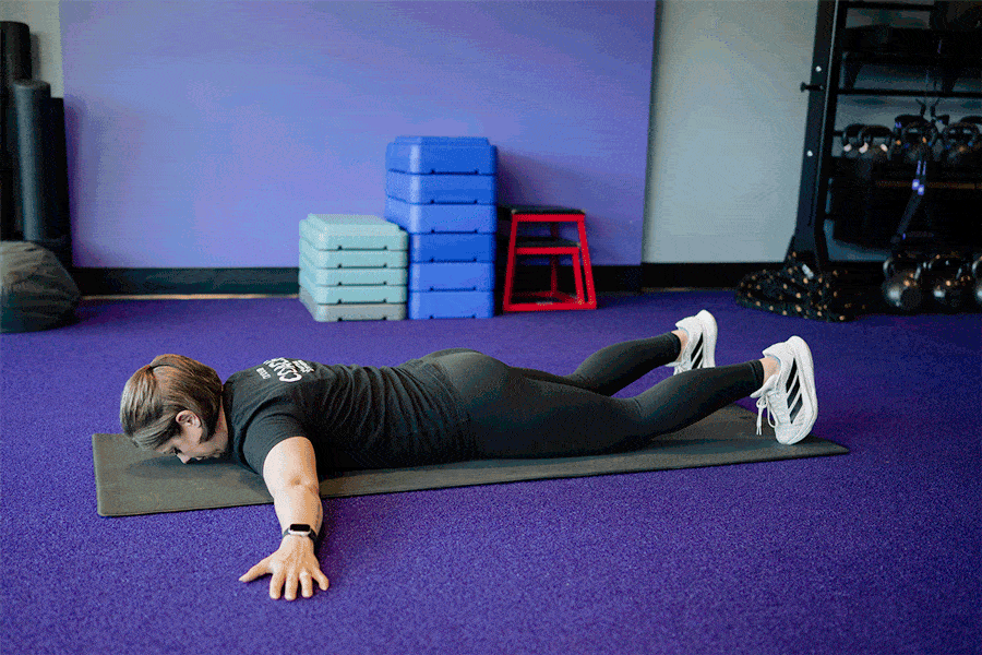 Anytime Fitness Coach demonstrating a Superman T-hold.