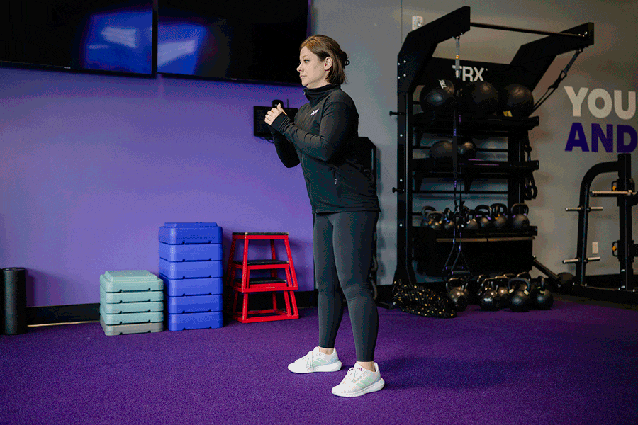 AF Coach Heather demonstrates a squat.