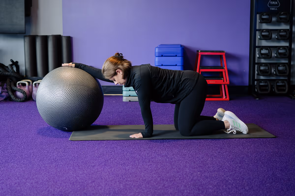 AF Coach Heather demonstrates static ball lat stretch.