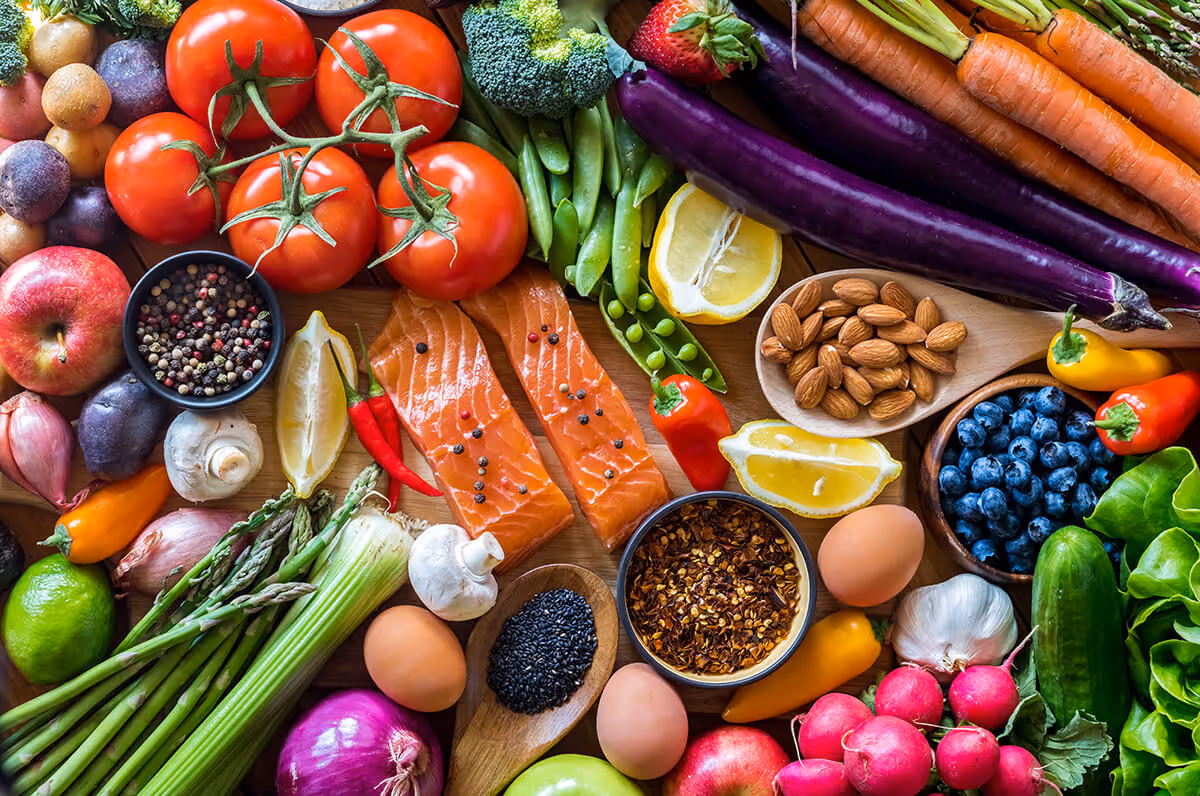 An arrangement of colorful fruits, vegetables and salmon.