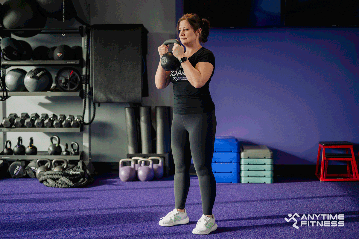 An AF Coach performs a squat.
