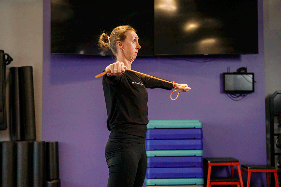 Anytime Fitness Coach demonstrating shoulder circles for shoulder mobility.