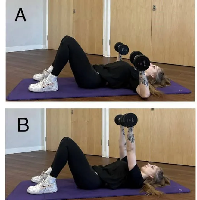 Person lying on a mat performing dumbbell chest presses, shown in starting (A) and lifting (B) positions indoors.