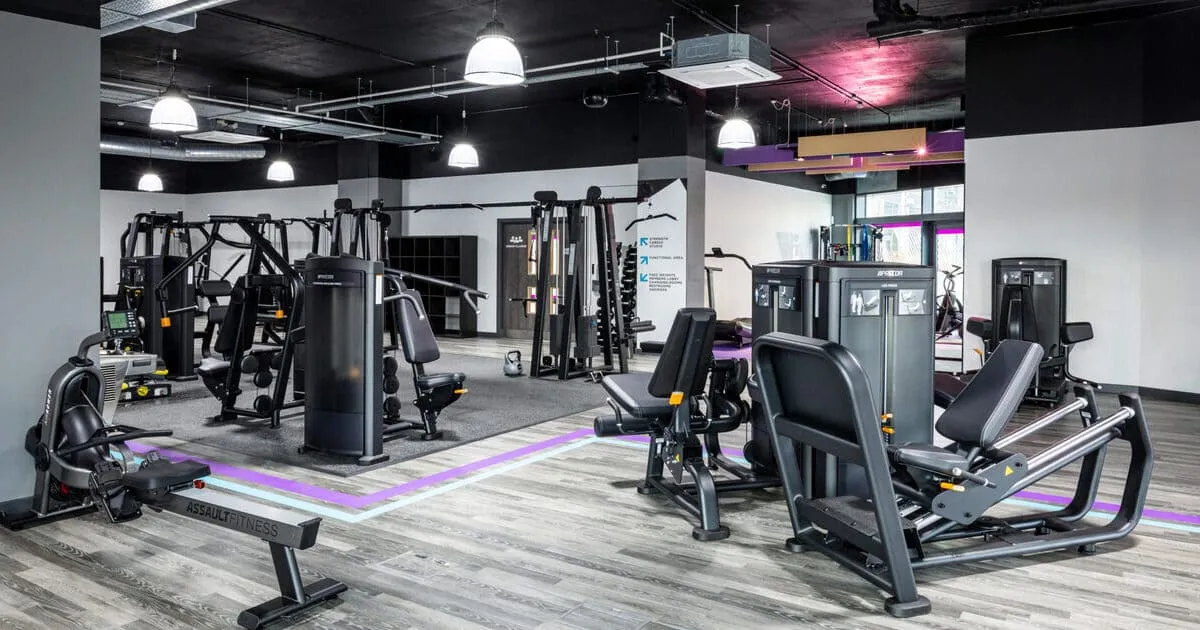 Spacious, modern gym interior with various exercise machines, including weight and cardio equipment. 