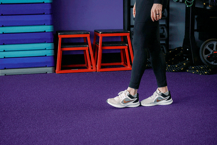 Anytime Fitness Coach demonstrating heel-to-toe walking, a strength and balance exercise.