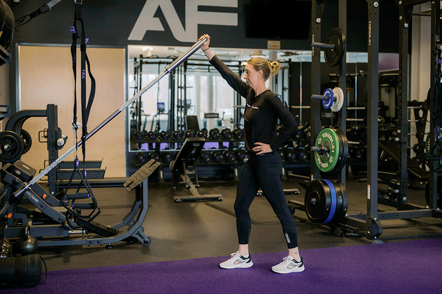 Anytime Fitness Coach demonstrating a landmine press.