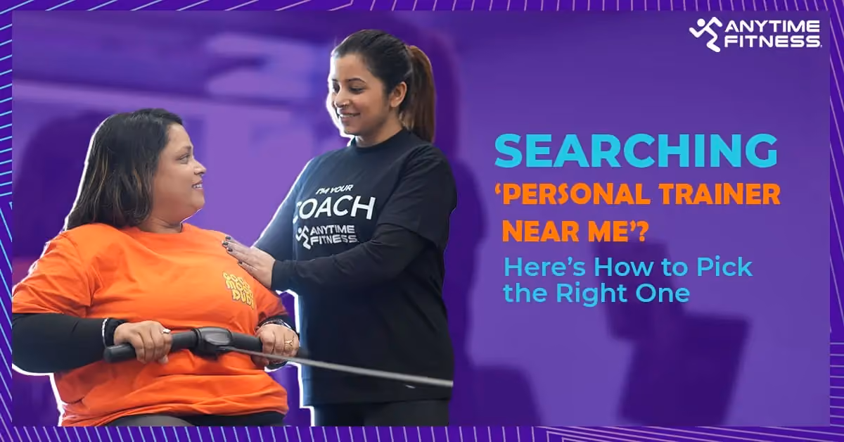 Anytime Fitness trainer assisting a woman using gym equipment with text ‘Searching Personal Trainer Near Me? Here’s How to Pick the Right One’.