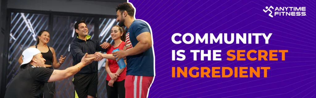 Anytime Fitness banner featuring the text "Community is the Secret Ingredient." It shows a diverse group of gym members smiling and shaking hands, emphasizing a friendly and supportive fitness environment.