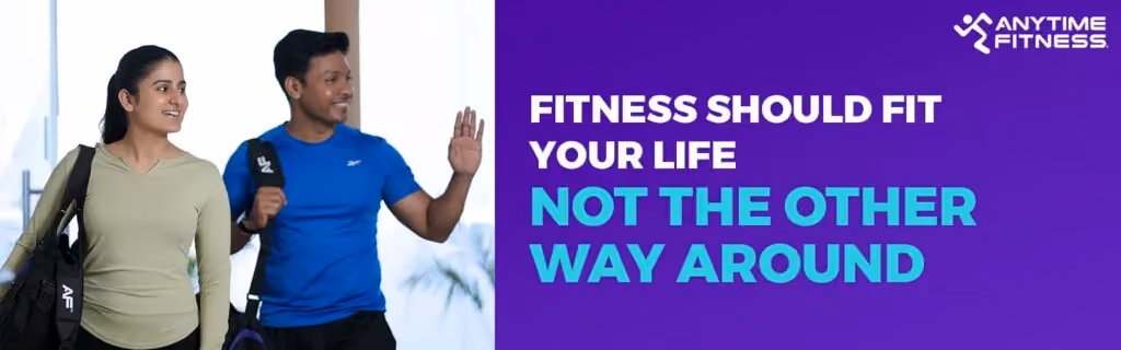 Anytime Fitness banner with the text "Fitness Should Fit Your Life, Not The Other Way Around." On the left, a man and a woman are shown smiling and carrying gym bags, looking ready for a workout that fits into their daily schedule.