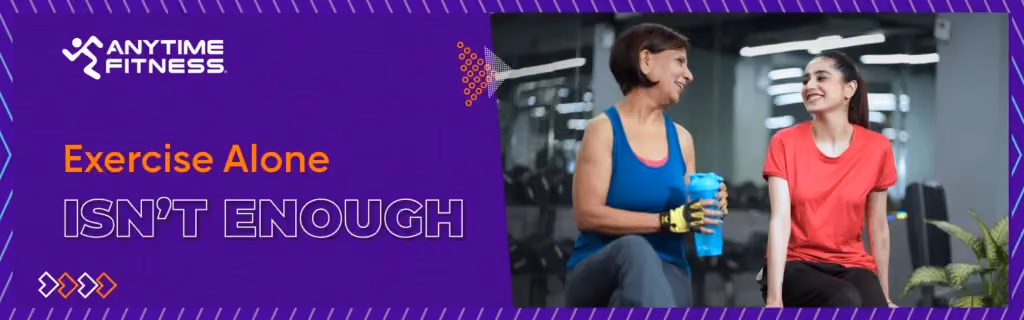 Anytime Fitness banner with the text "Exercise Alone ISN'T ENOUGH." The right side depicts a positive social moment between two women of different generations chatting and smiling in a gym during a workout break.
