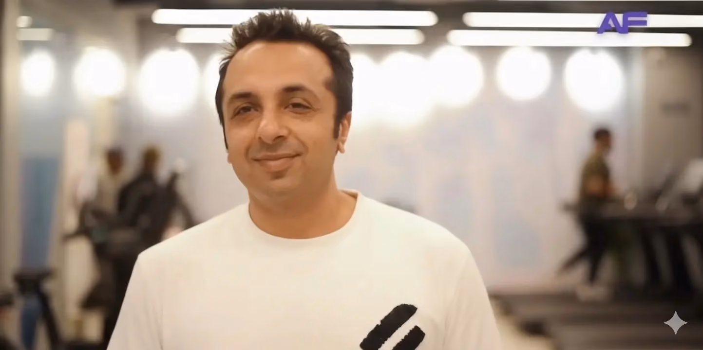 Samrat Bhalla, Anytime Fitness multi-club owner from Delhi NCR, standing inside a gym with cardio equipment in the background.