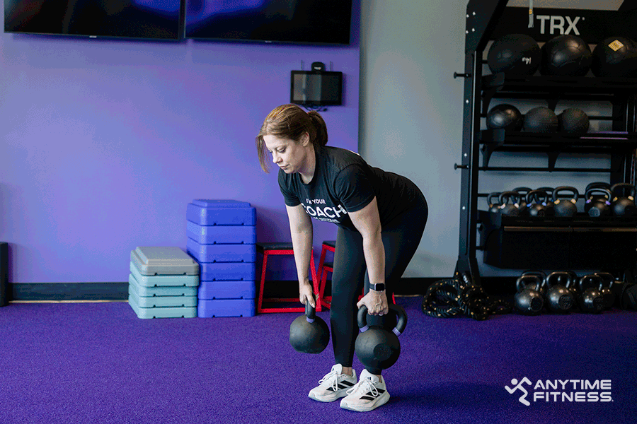 An AF Coach is doing deadlifts in the gym.