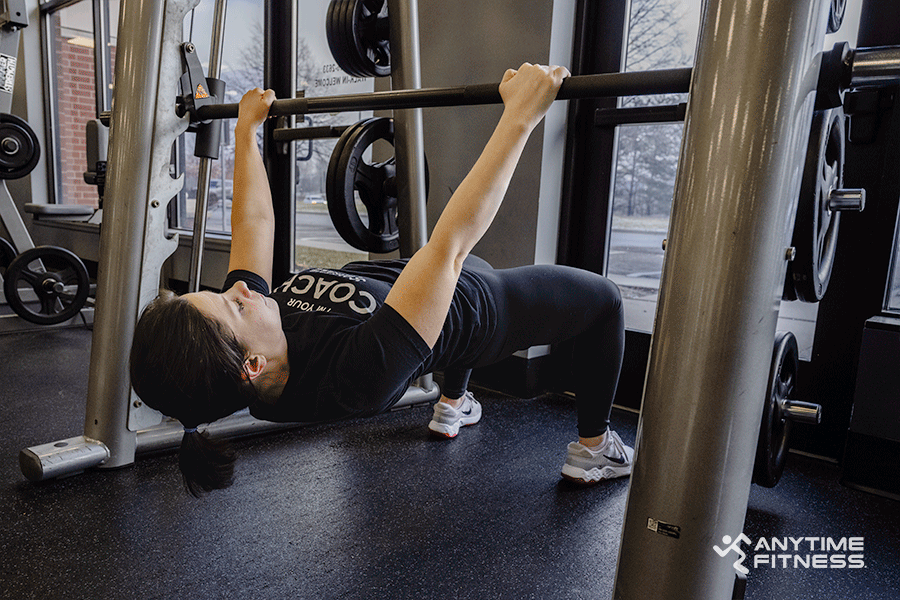 Anytime Fitness Coach demonstrating how to do an inverted row. 