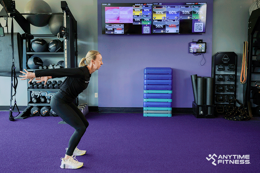 Anytime Fitness Coach demonstrating how to do a broad jump. 