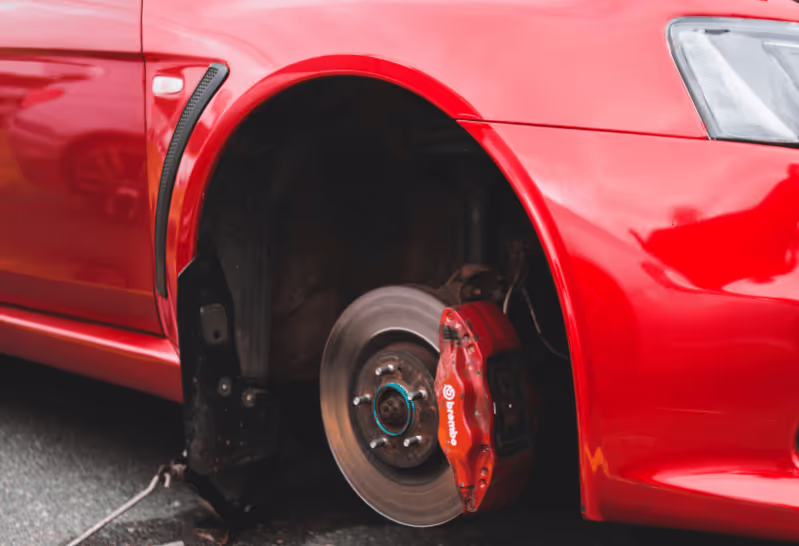 Red car with no tire