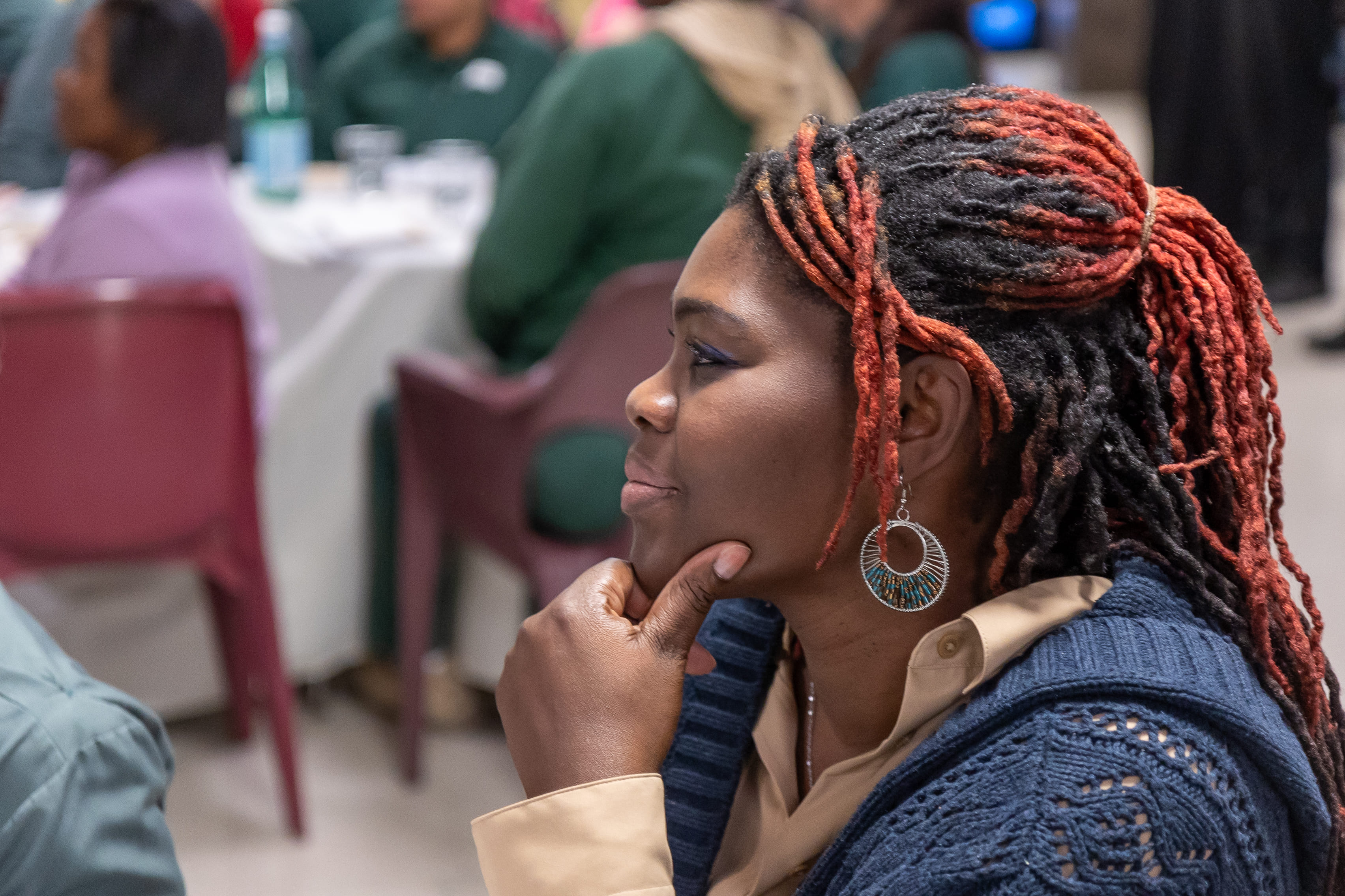 A woman listening during the dinner conversation.