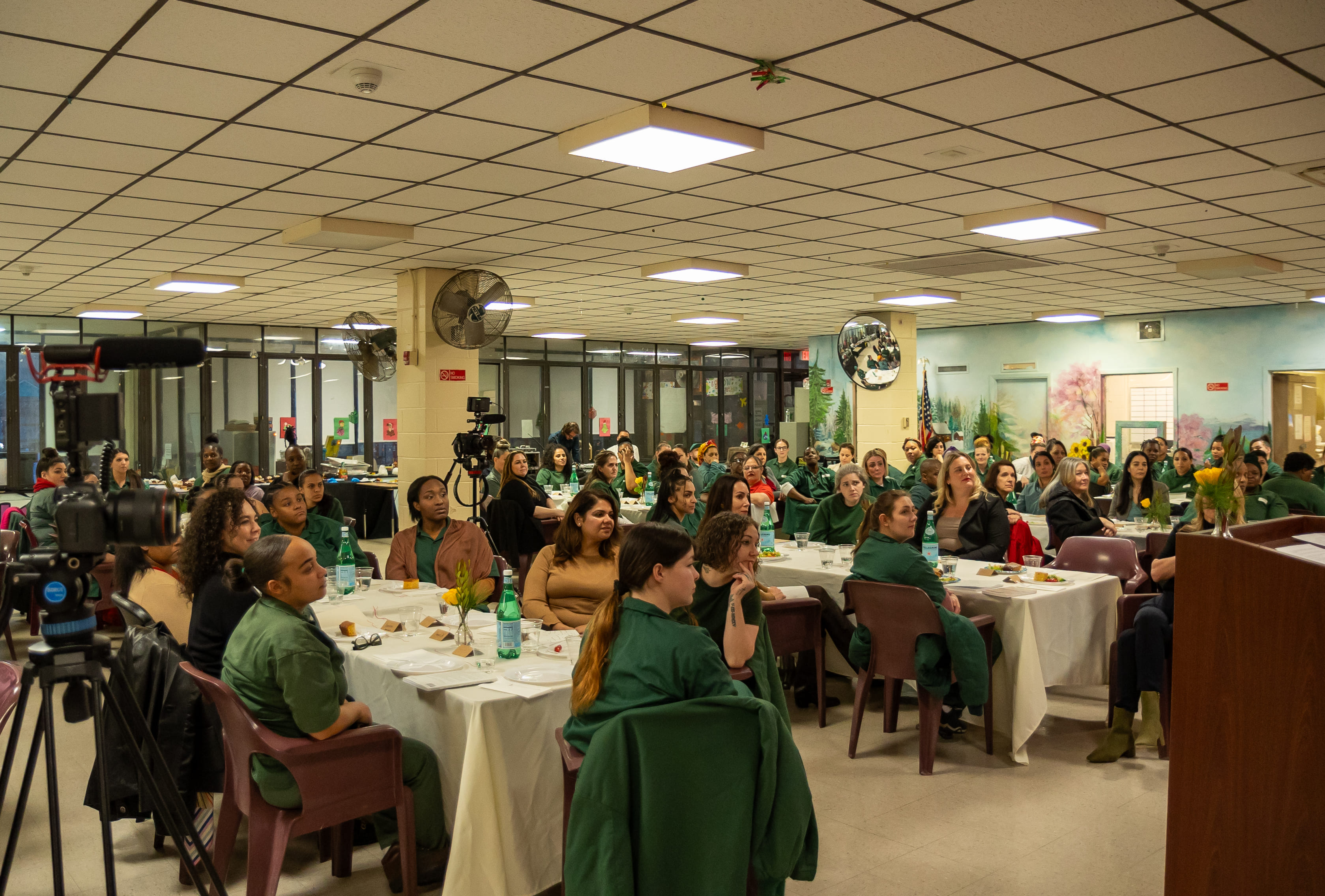 Guests and participants seated at dinner tables in the Taconic dining hall.
