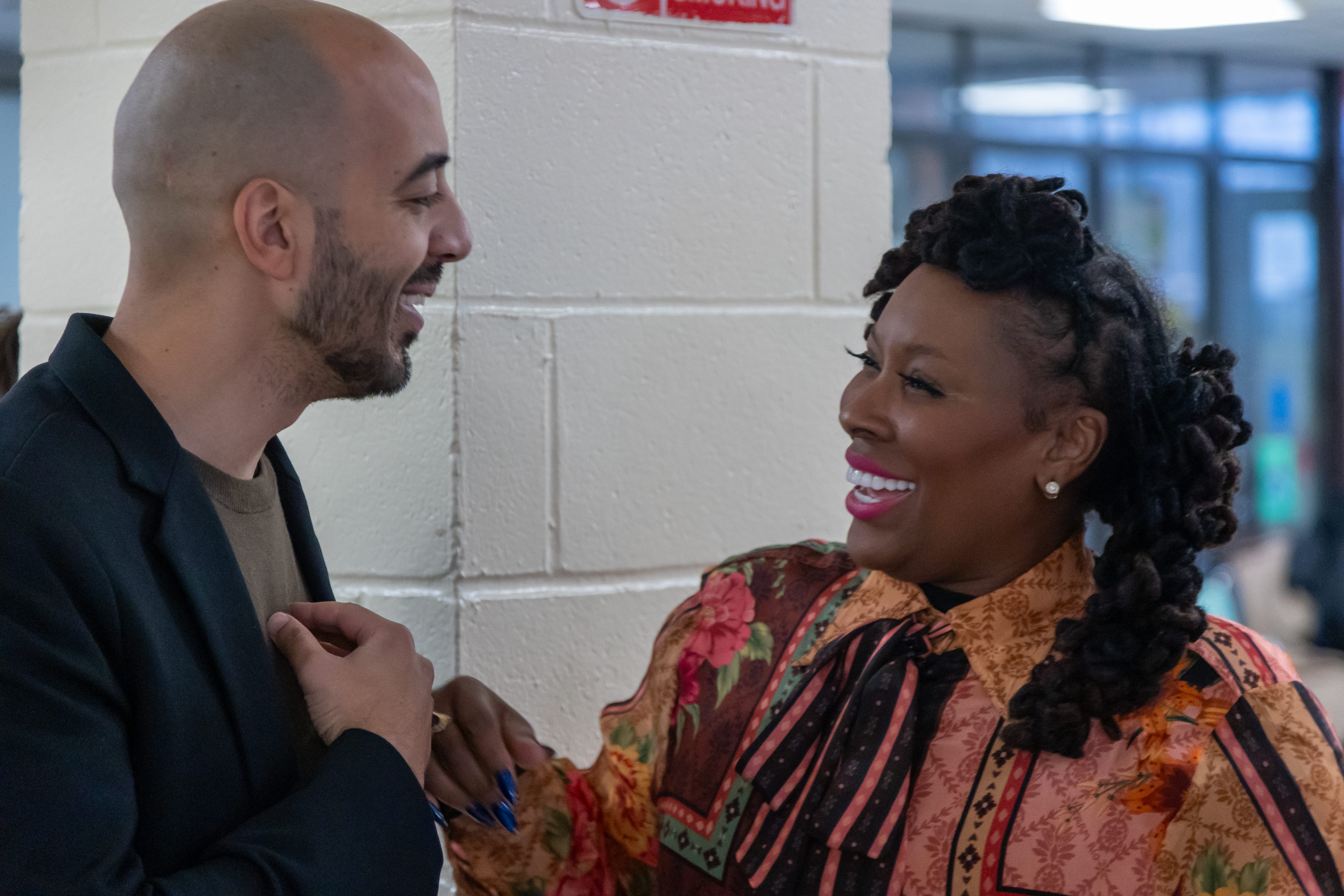Dr. Topeka K. Sam in conversation with a guest, both smiling.