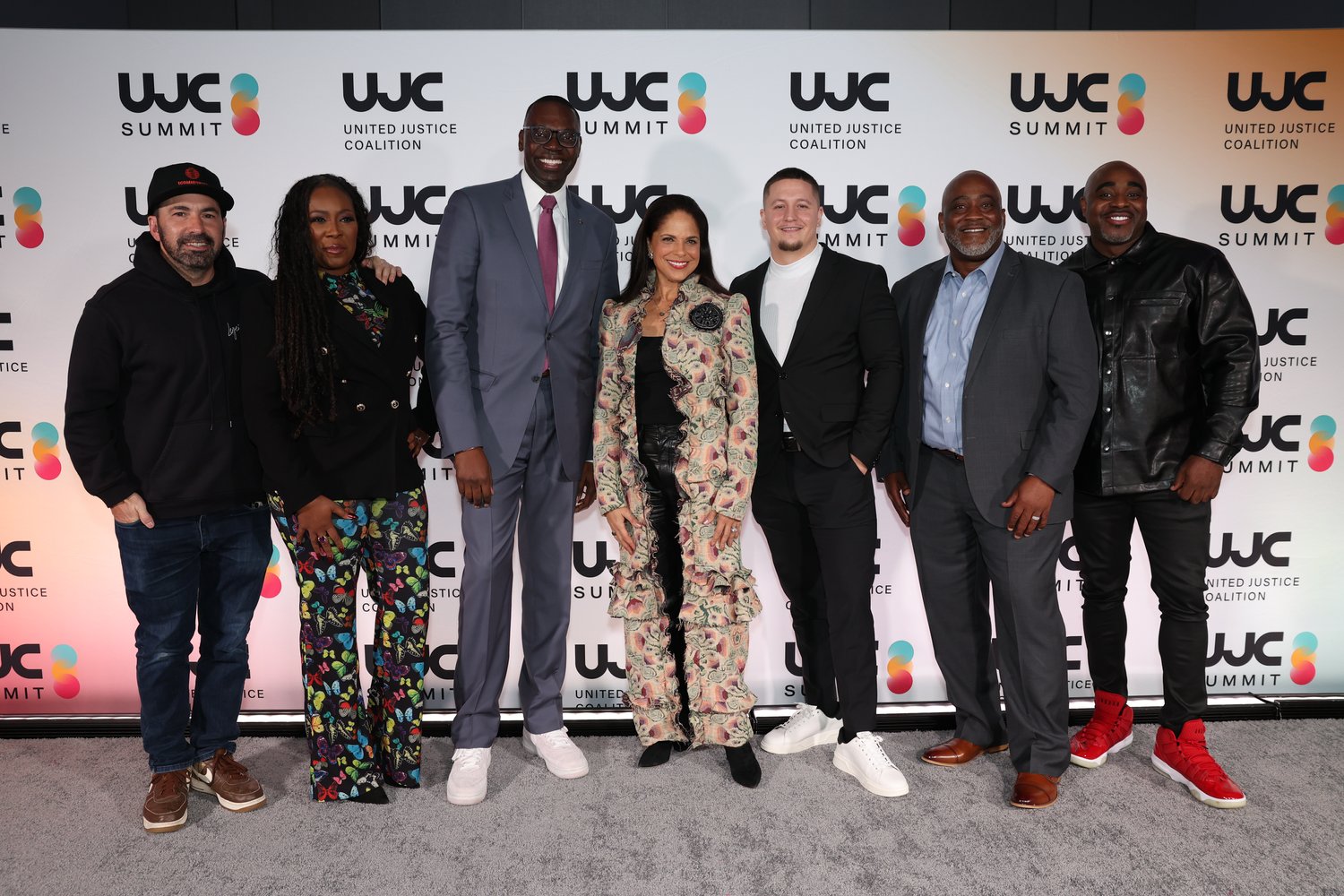 Two guests posing at the UJC Summit step and repeat.
