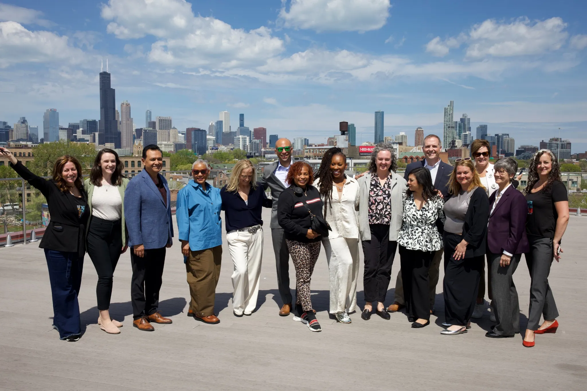 Women's Justice Commission members on a rooftop with the Chicago skyline behind them.