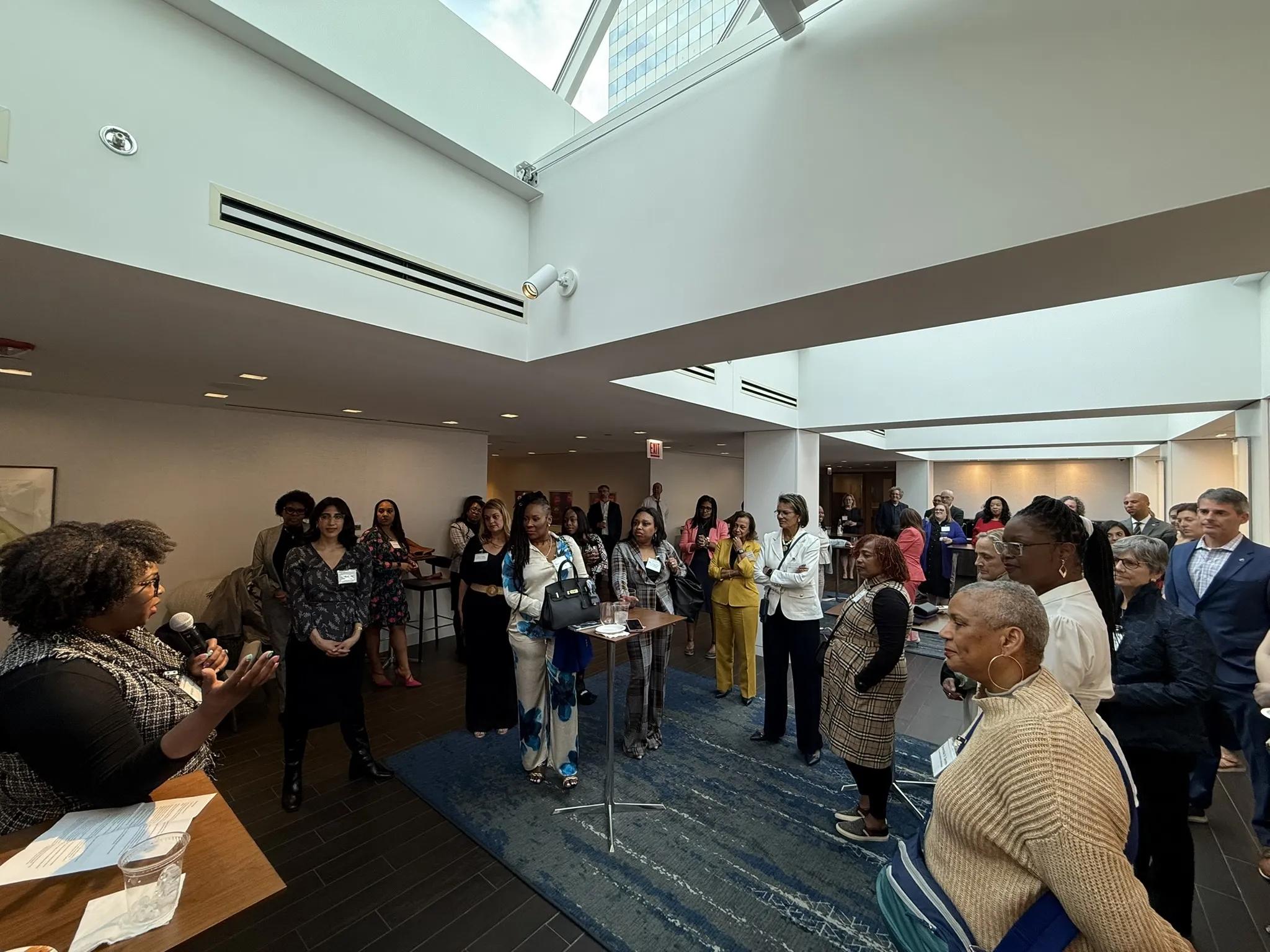 Attendees gathered around a podium during the Women's Justice Commission Conference.