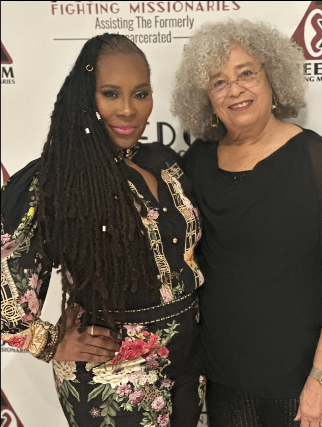 Dr. Topeka K. Sam and Dr. Angela Y. Davis at the Freedom Fighting Missionaries backdrop.