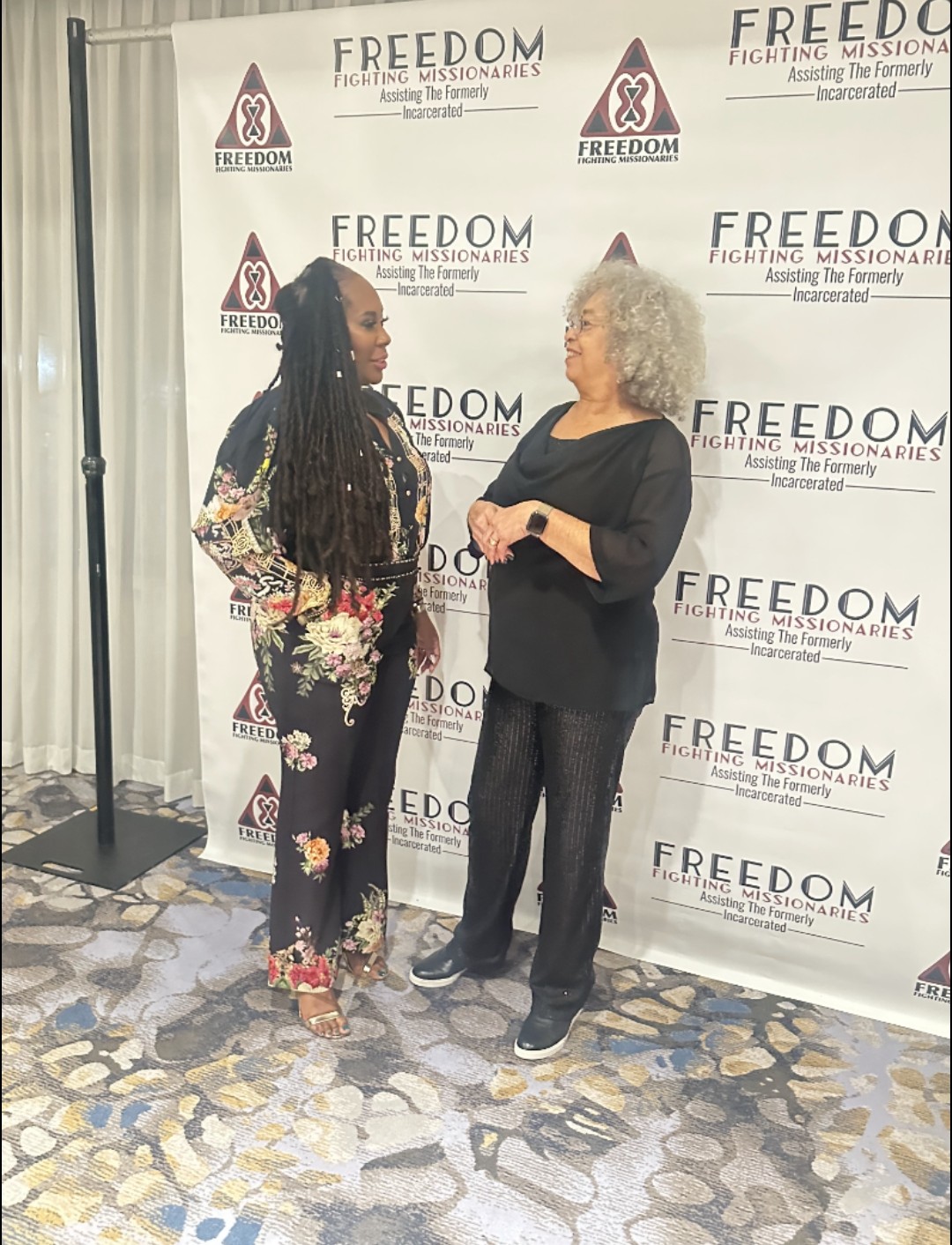 Full-length photo of Dr. Topeka K. Sam and Dr. Angela Y. Davis at the gala.