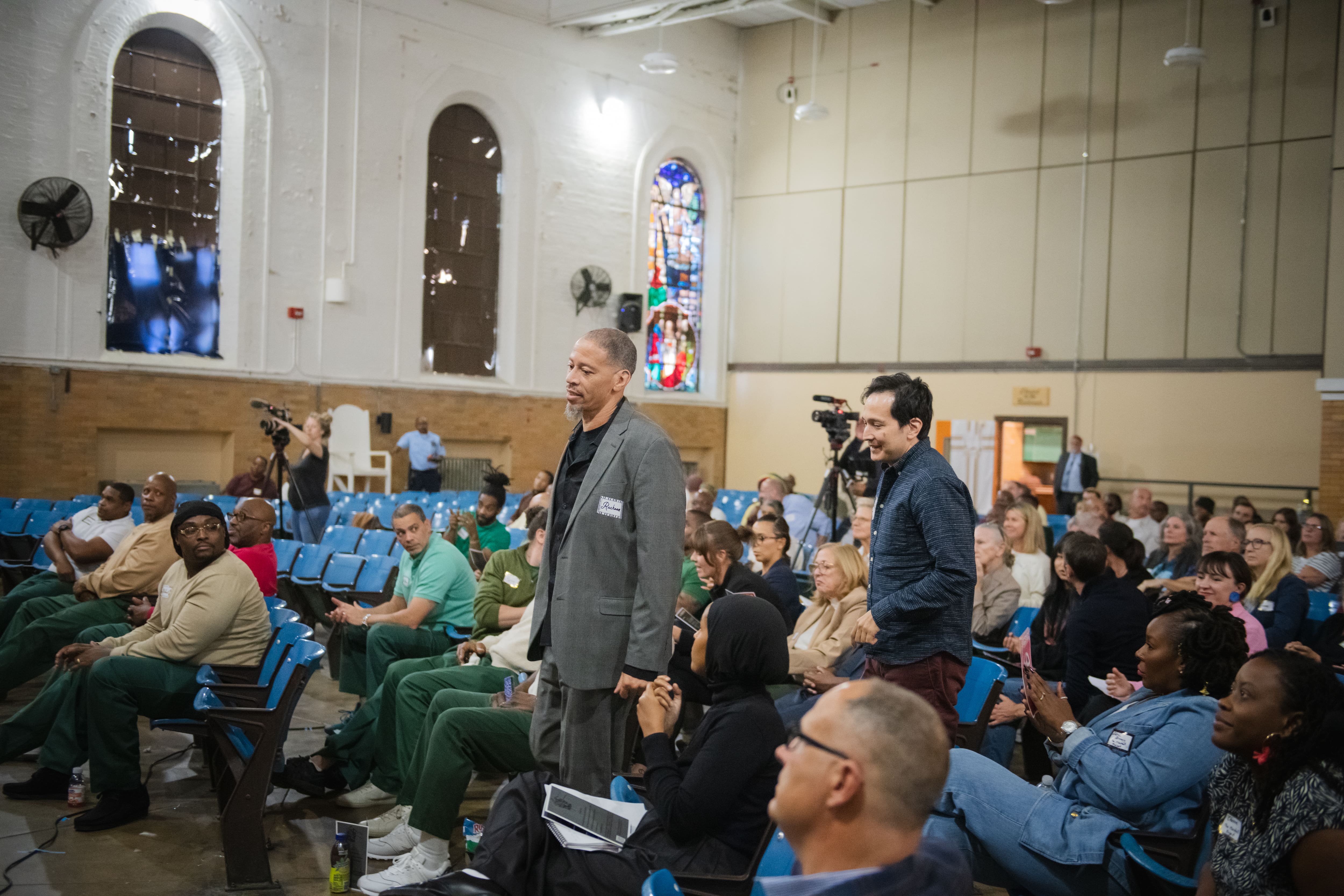 A speaker addresses a seated audience at the Sing Sing Film Festival.