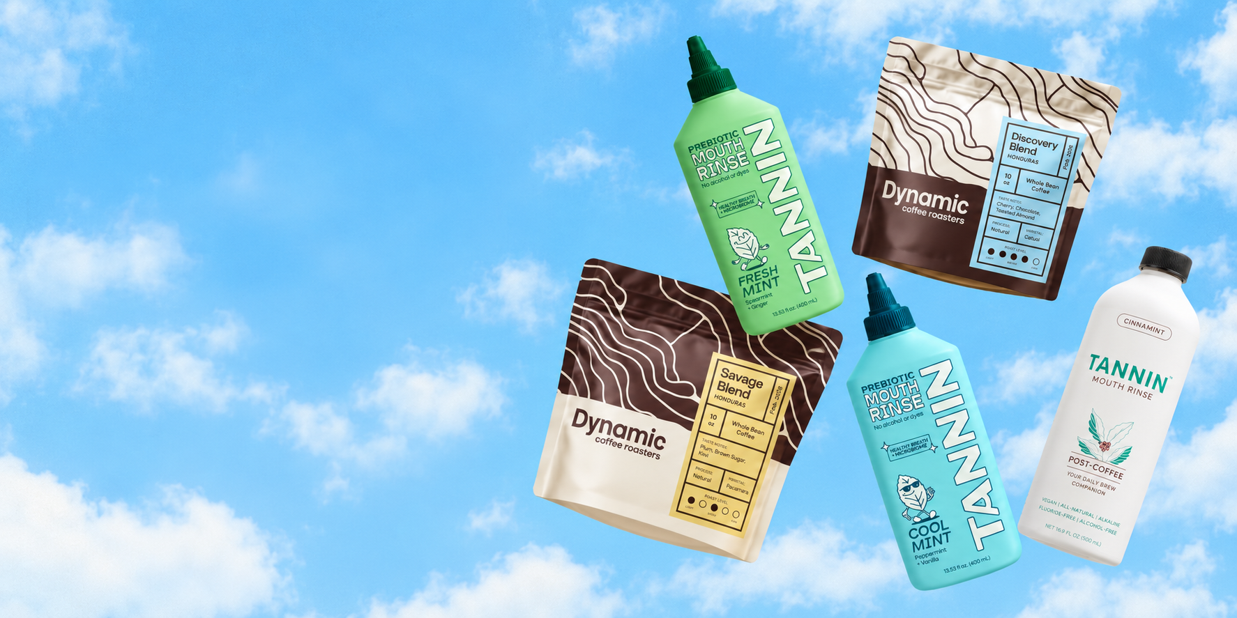 Four products floating against a bright blue sky with clouds: two Dynamic Coffee Roasters whole bean coffee bags labeled Savage Blend and Discovery Blend from Honduras, and two Tannin prebiotic mouth rinse bottles in green and blue labeled Fresh Mint and Cool Mint, plus a white bottle labeled Tannin Mouth Rinse Cinnamint.