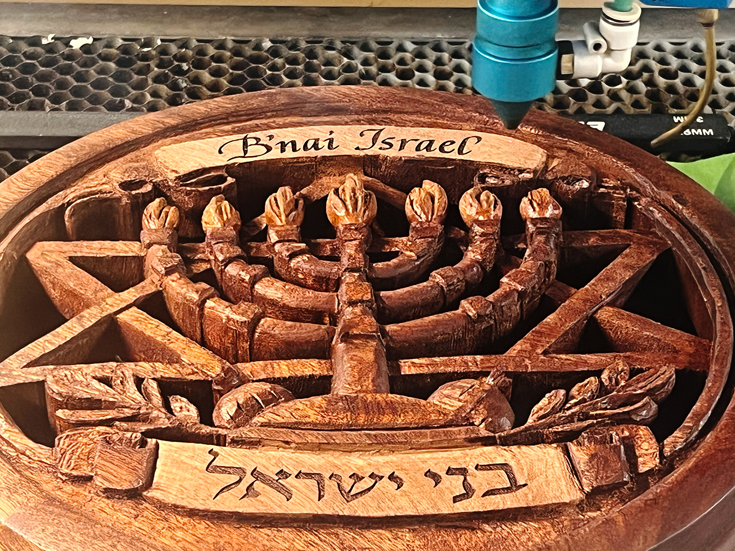 Hand calligraphy that was engraved and then laser engraved onto wood that was hand carved by Larry Smotroff