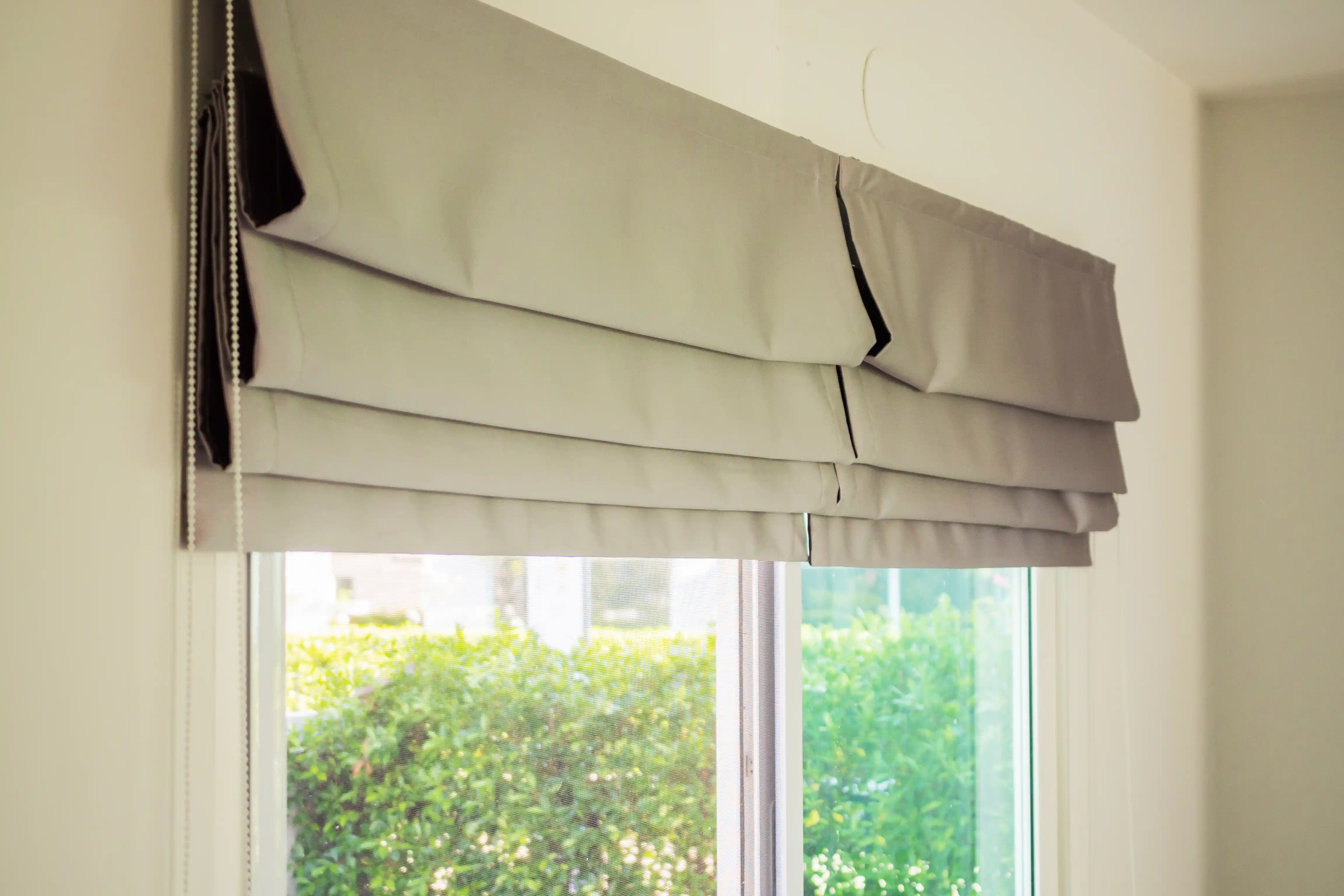 Window blinds blocking summer heat to keep indoor rooms cool without air conditioning 