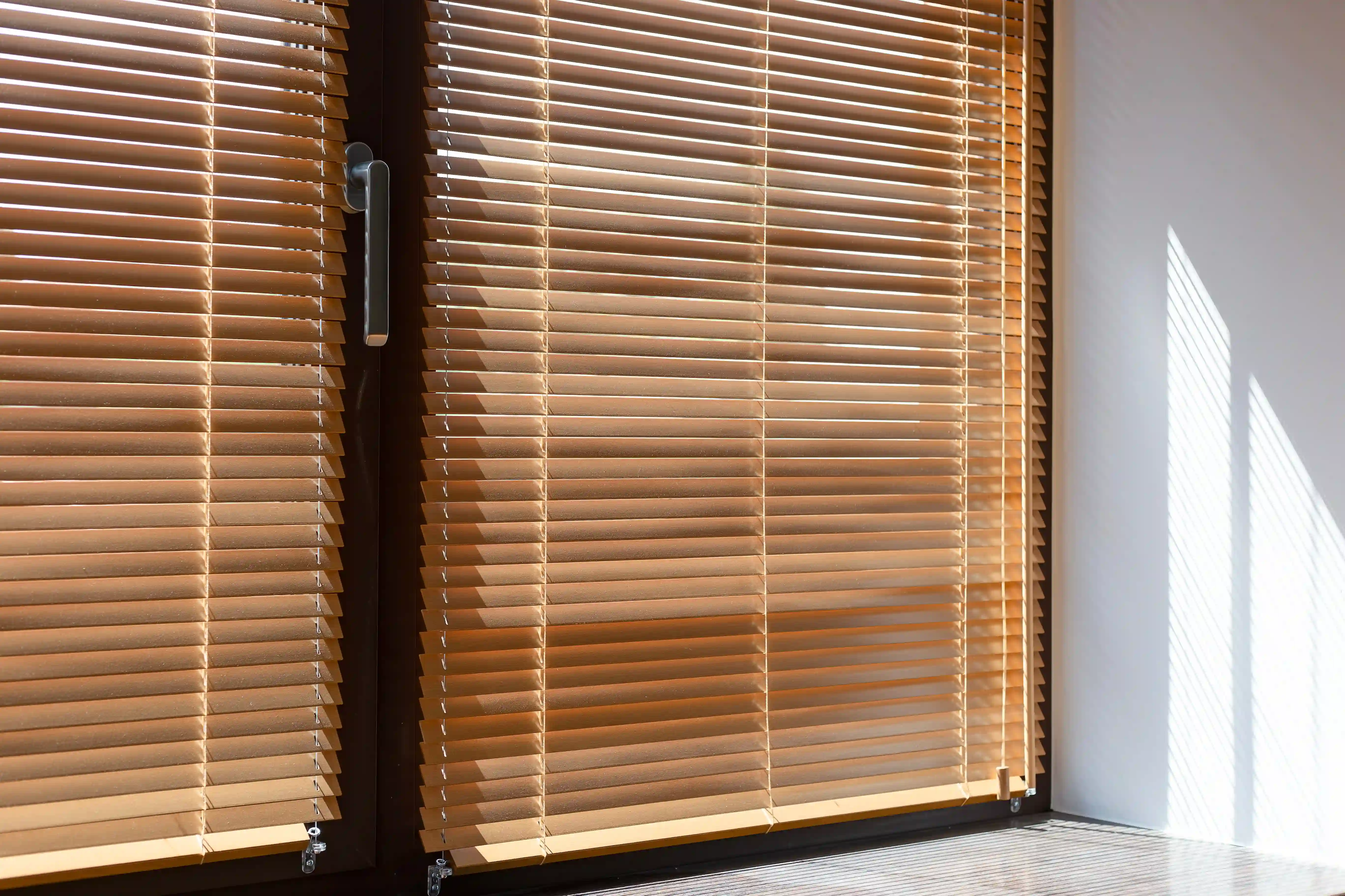 Wooden blinds provide superior heat control, with slatted wood effectively blocking afternoon sun rays.