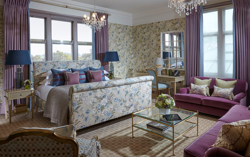 a beautiful bedroom with a bed, sofa and couches