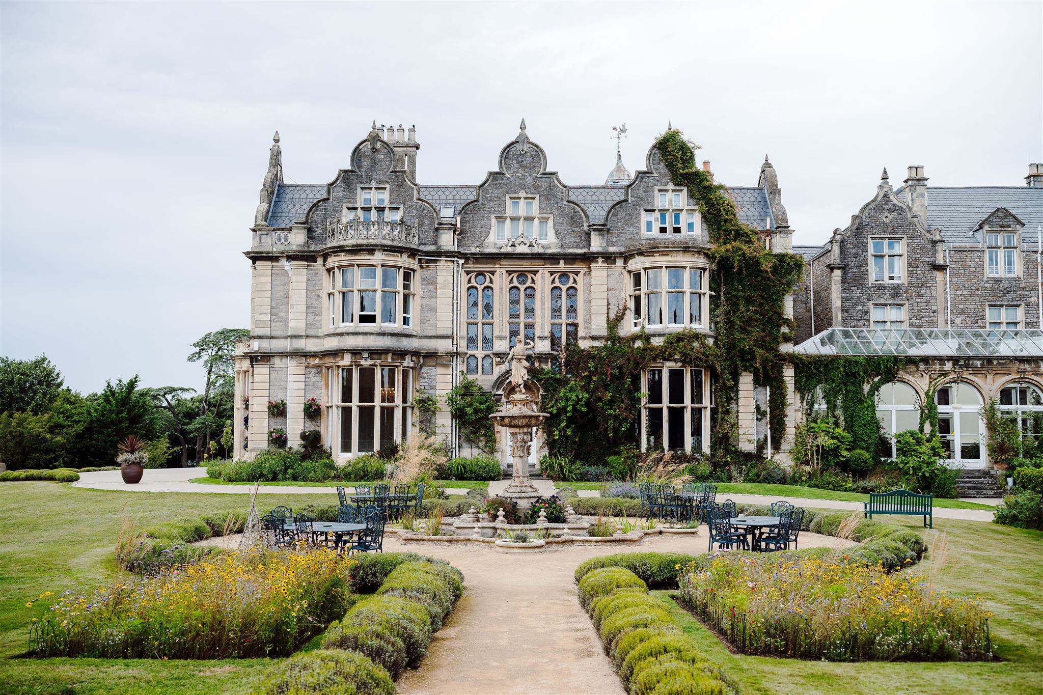 a large stone building with a fountain in front of it